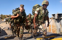 U.S. soldiers board a troop-transport boat near the West Nile city of Alexandria.